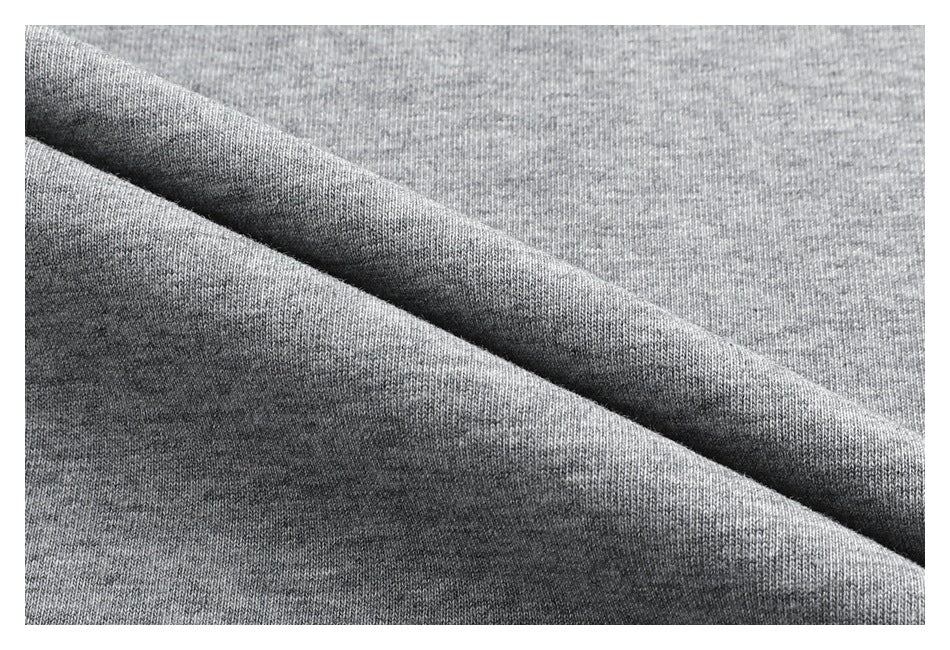 Close-up of gray knit fabric folded to show its surface and reverse texture.