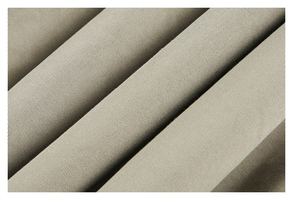 Close-up of several folds of smooth light khaki fabric.