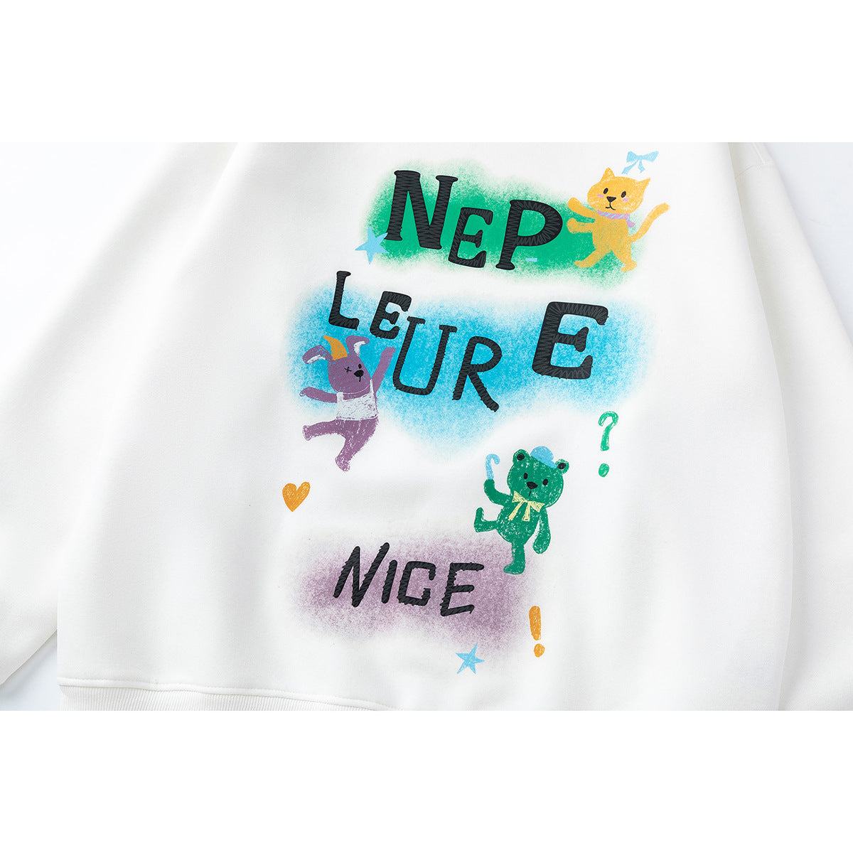 Close-up of a white sweatshirt with colorful cartoon animals, stars, and stylized lettering.