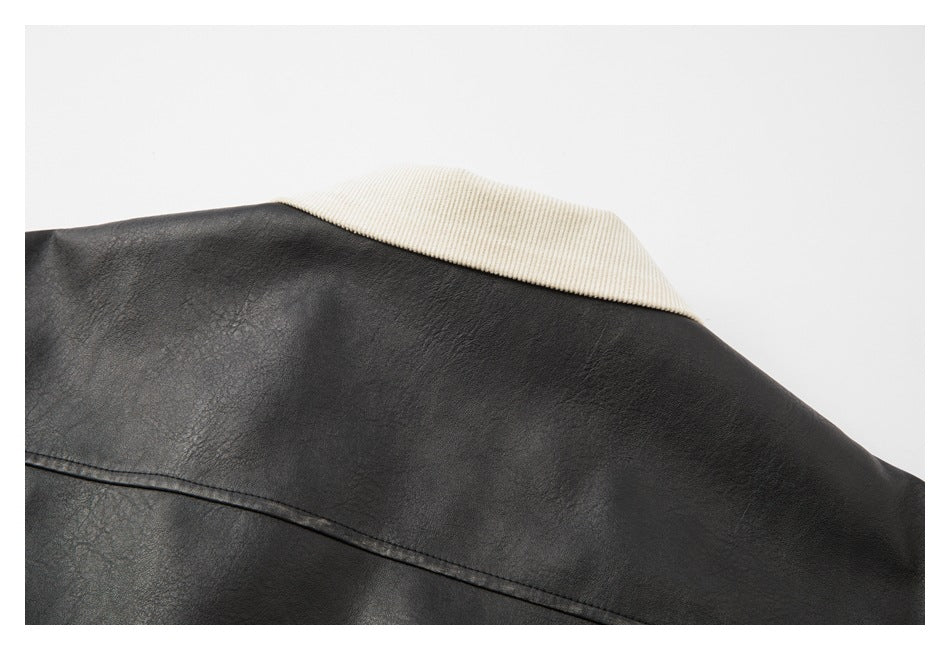 Close-up of a black jacket's back shoulder and contrasting cream ribbed collar.