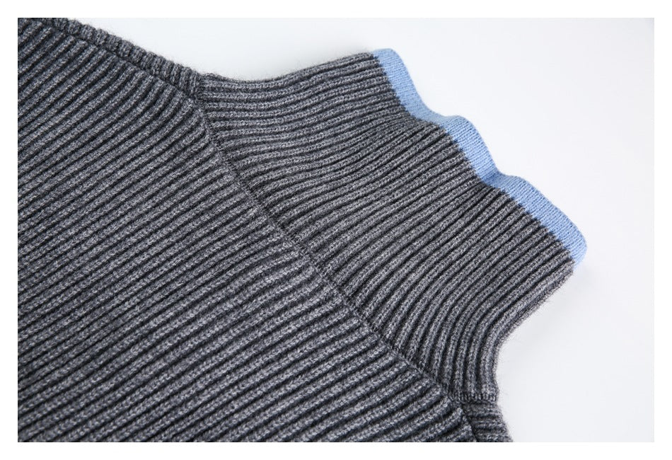 Close-up of a charcoal rib-knit neckline edged with light blue trim.