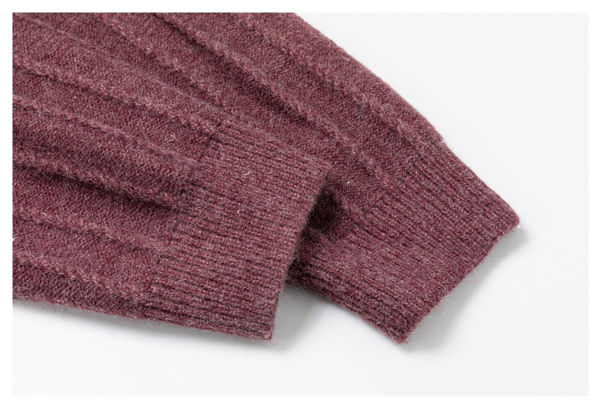 Close-up of two ribbed cuffs on a burgundy knit garment.
