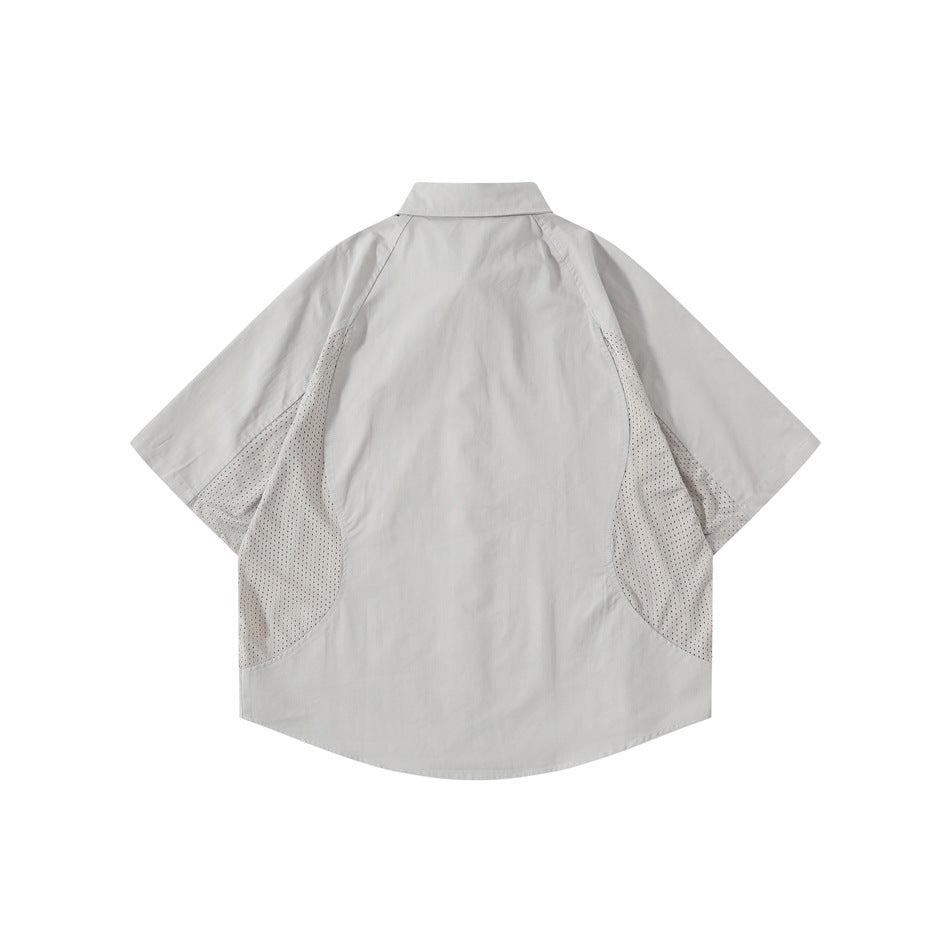Back view of a light gray short-sleeve button-up shirt with perforated mesh panels along the sides.