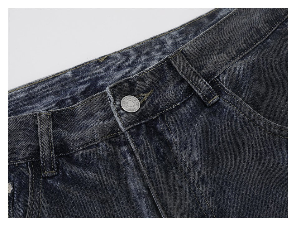 Close-up of dark washed jeans showing the waistband, belt loops, button, and fly.