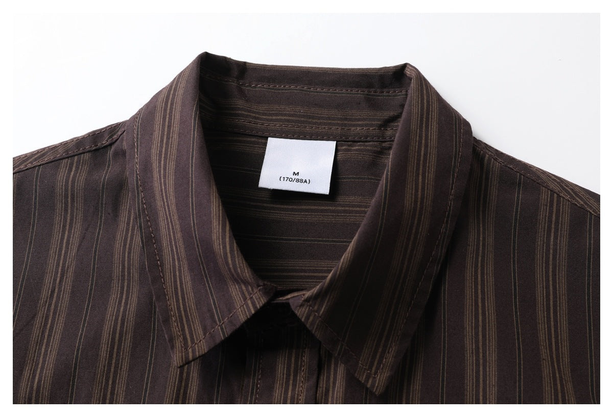 Close-up of a dark brown shirt collar with fine tan vertical stripes and a white size M label.