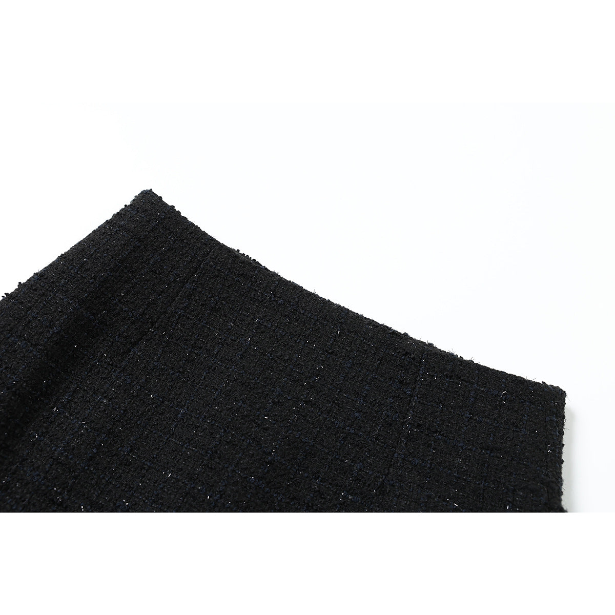 Close-up of black textured fabric with subtle flecks on a white background.