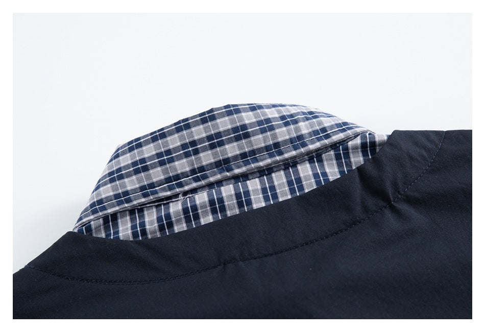 Close-up of a navy garment collar with blue, gray, and white plaid lining.