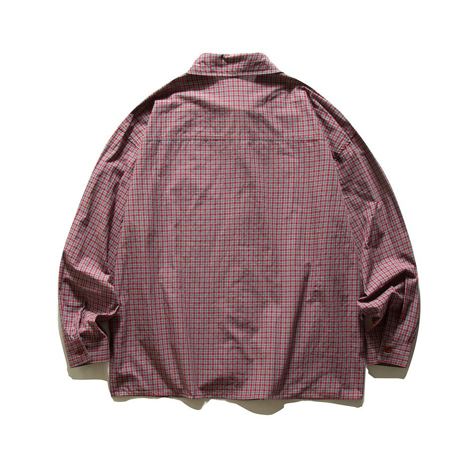 Back view of red small-check plaid long-sleeve shirt with back yoke seam and buttoned cuffs, flat lay