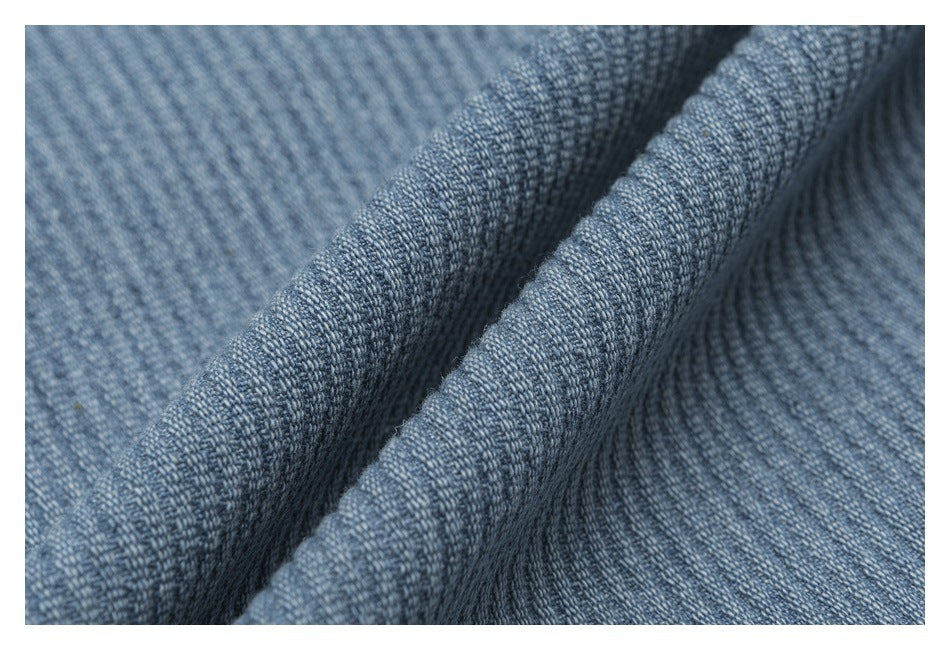 Extreme close-up showing the raised ribbed texture and folds of blue-gray fabric.