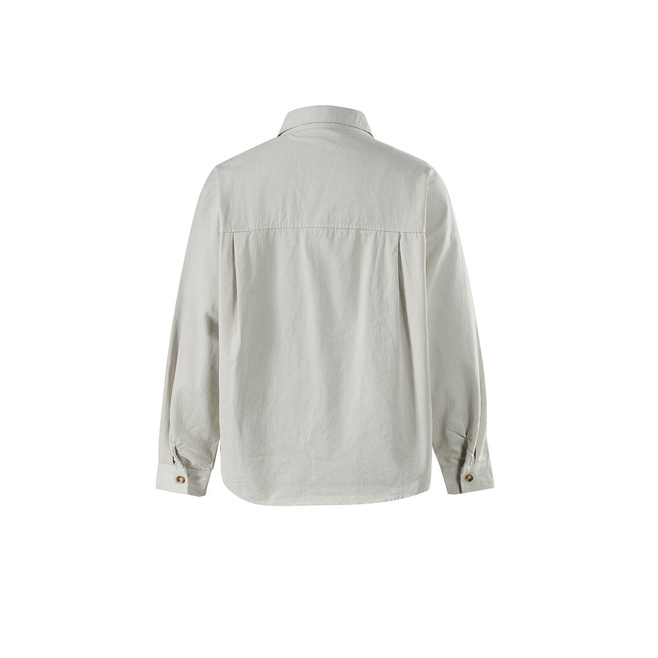 Back view of an off-white long-sleeve button-up shirt with a straight yoke and cuff buttons.