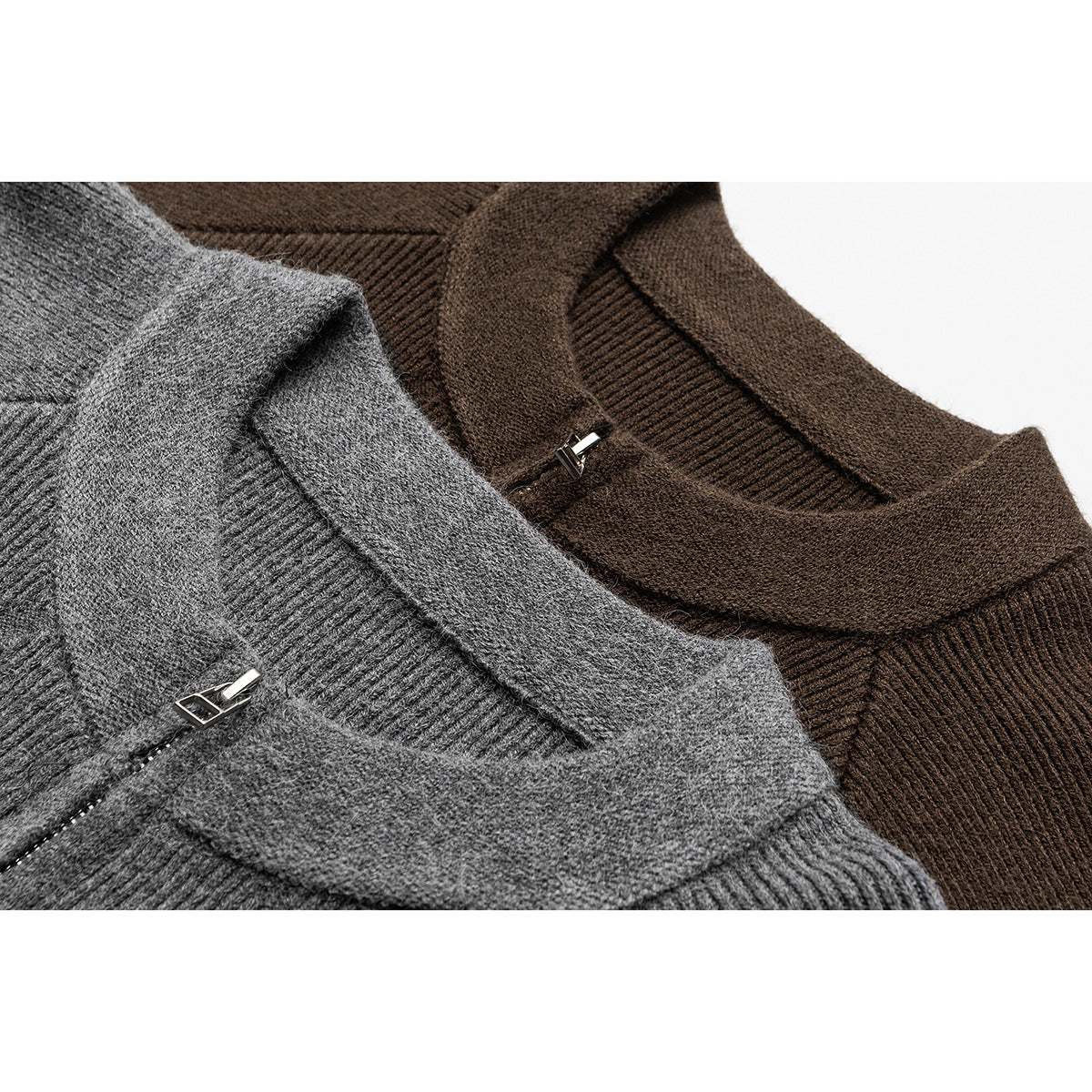 Close-up of gray and brown knit zip cardigans showing ribbed collars and silver zipper pulls.