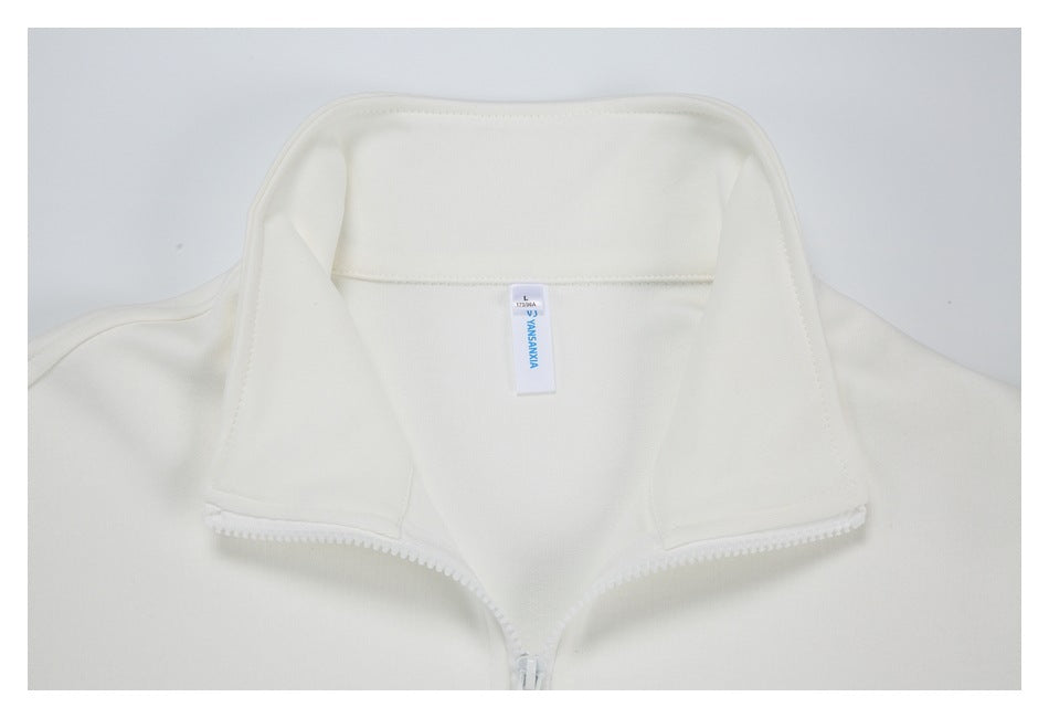 Close-up of an off-white jacket's inside stand collar, zipper, and small sewn-in neck label.