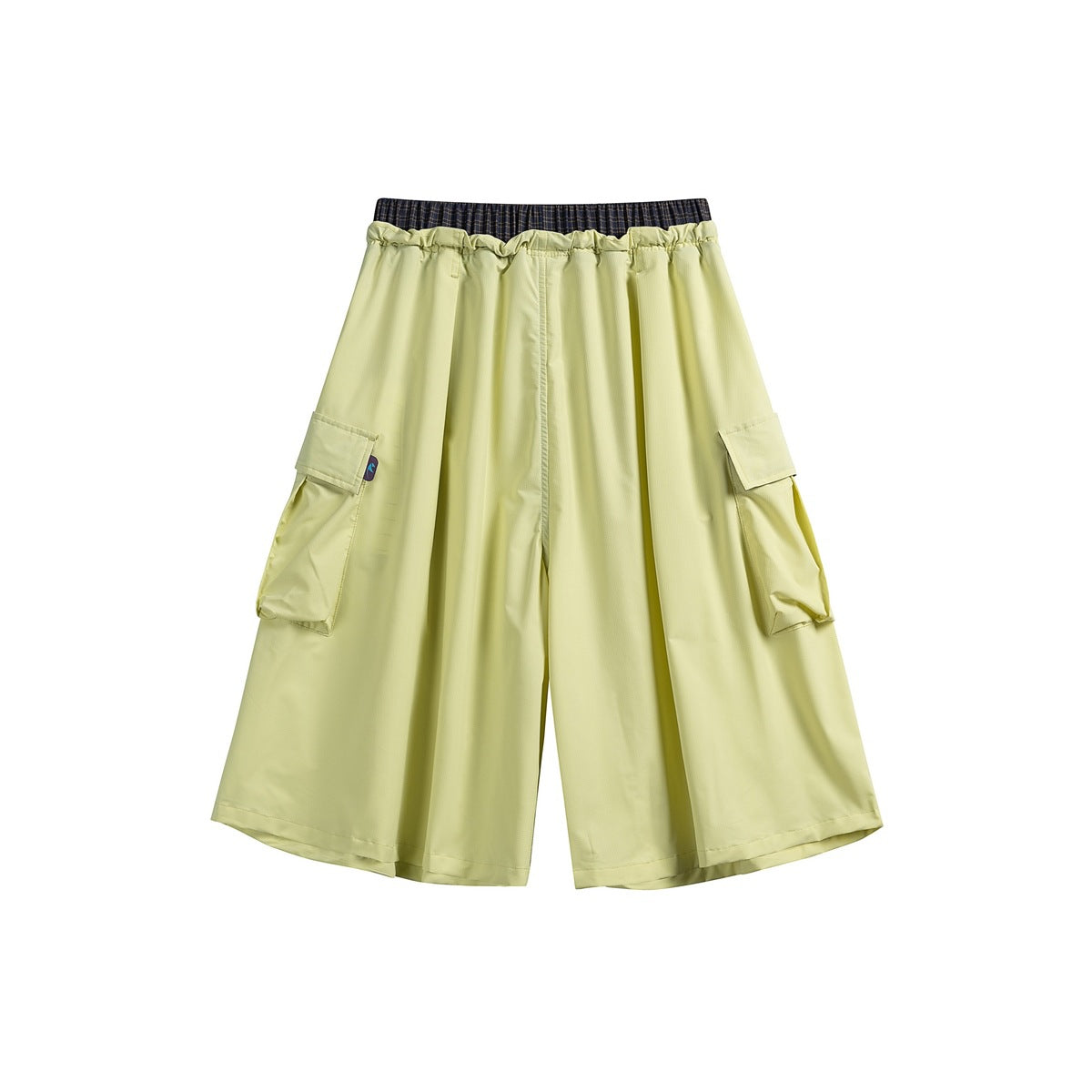 Pale yellow wide-leg cropped pants with an elastic waist, dark plaid waistband detail, and flap cargo pockets.