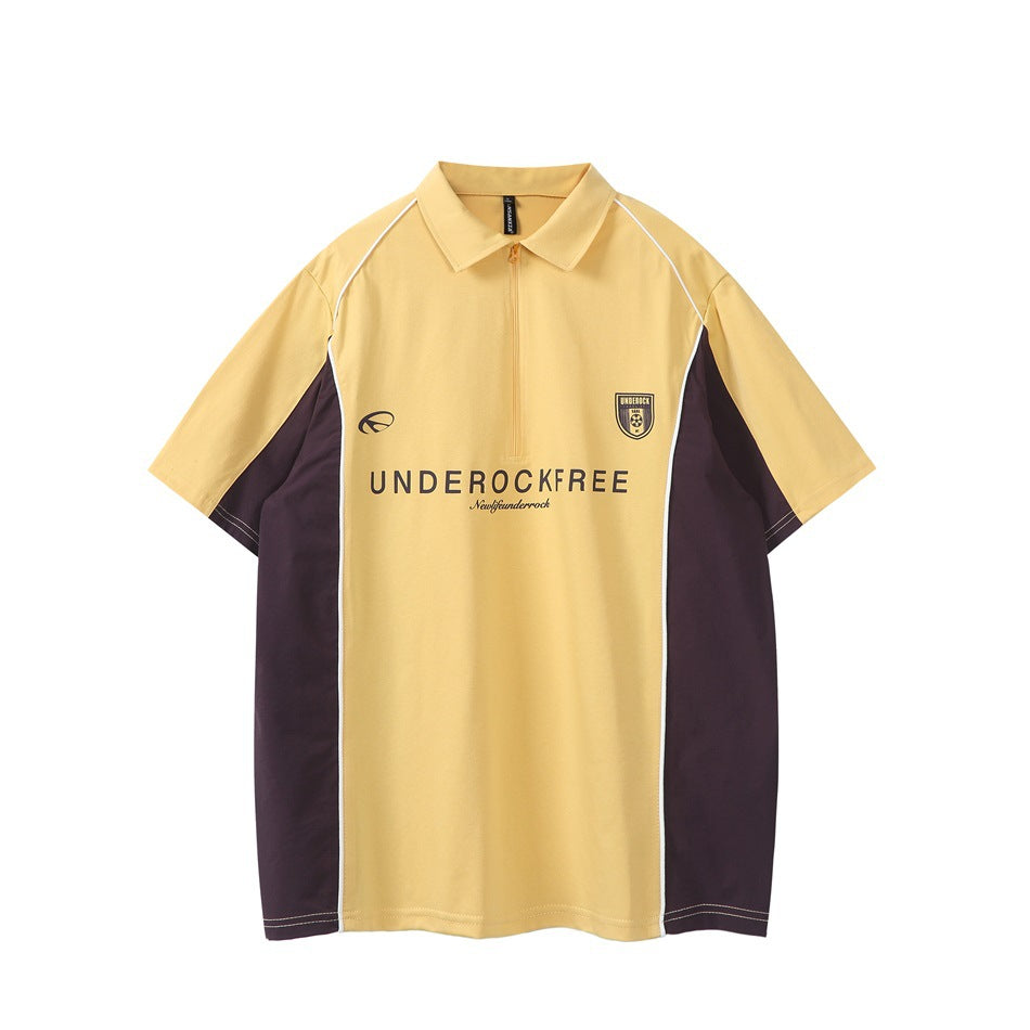 Yellow short-sleeve quarter-zip polo with dark brown-purple side panels, white piping and chest shield print, front view