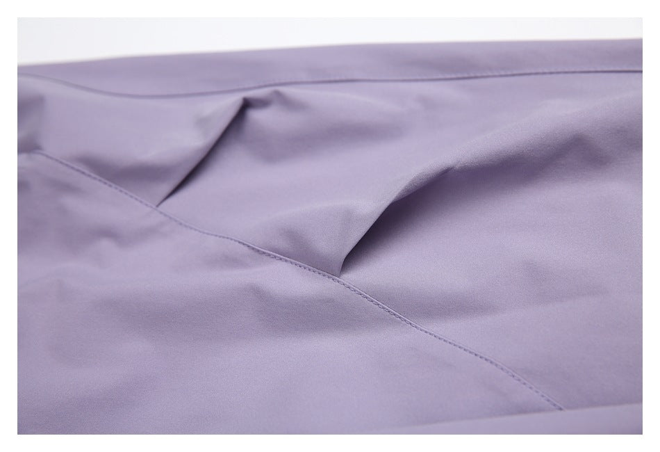 Close-up of stitched pocket construction on lavender trousers.