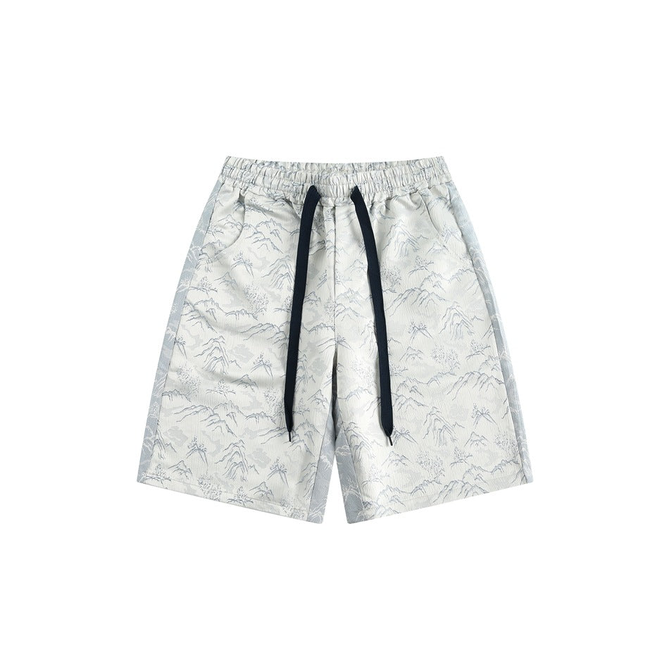 Off-white knee-length shorts with mountain pattern, navy drawstring and light blue side panels, front view