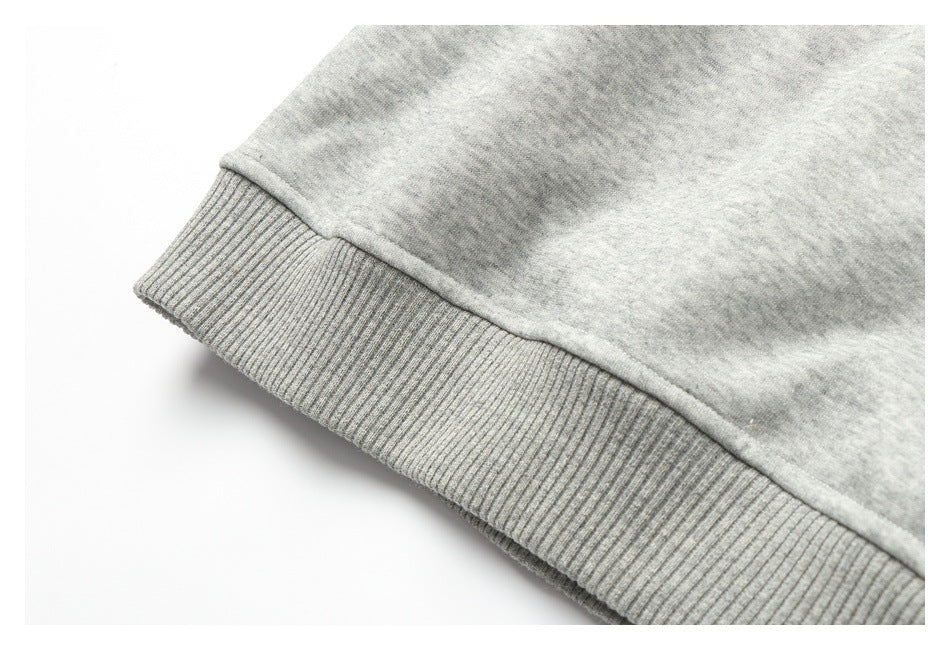 Close-up of a ribbed cuff or hem on a light heather-gray garment.