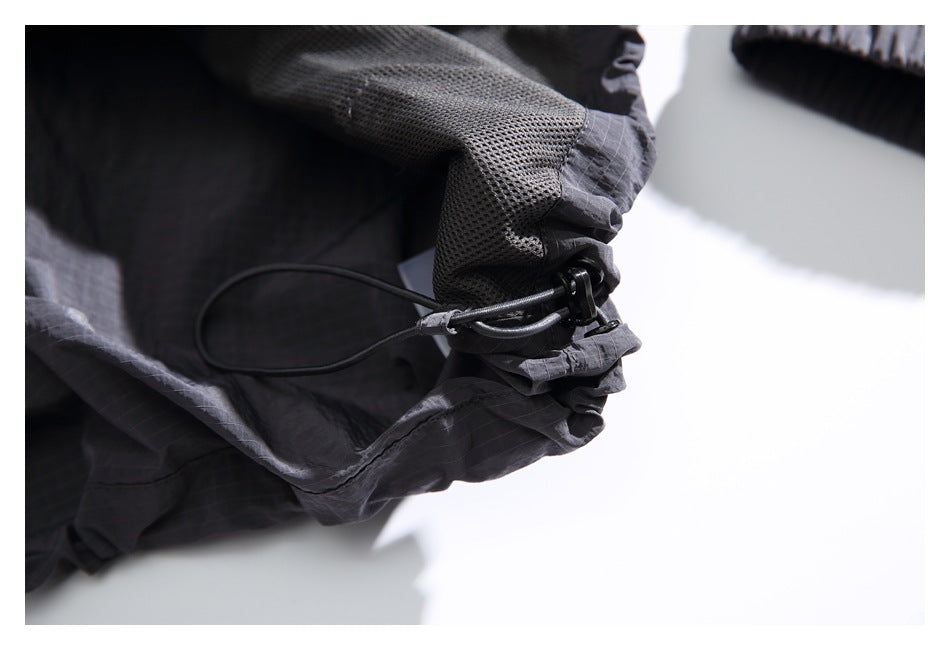Close-up of the jacket hood’s mesh lining and adjustable drawcord toggle.
