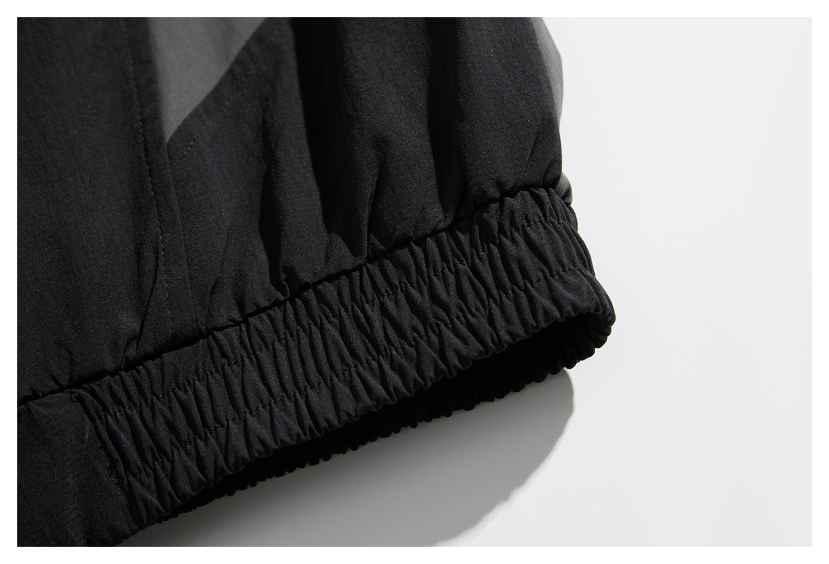Close-up of the gathered elastic hem on a black jacket.