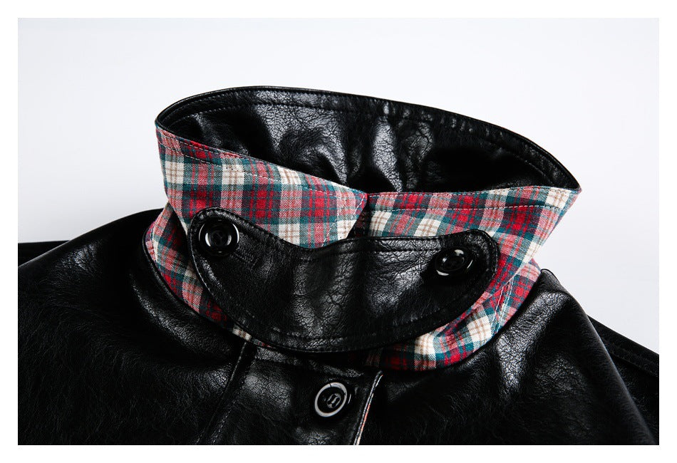 Close-up of the jacket's raised plaid collar, black buttoned tab, and front button.