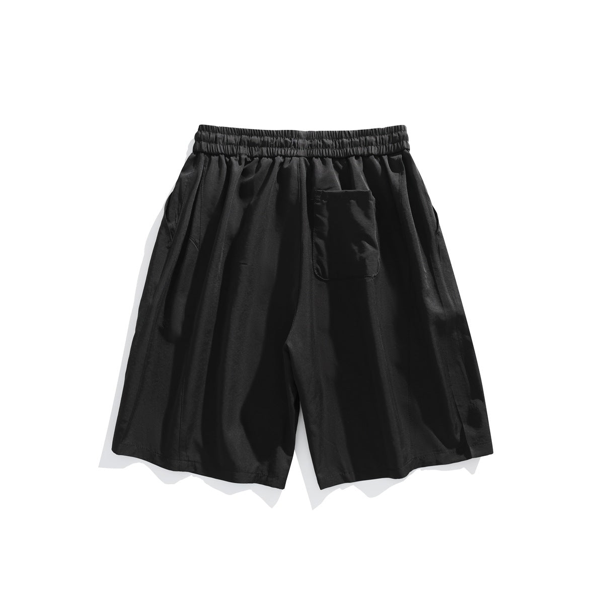 Black shorts back view with elastic waistband, back patch pocket and vertical leg seams, flat lay