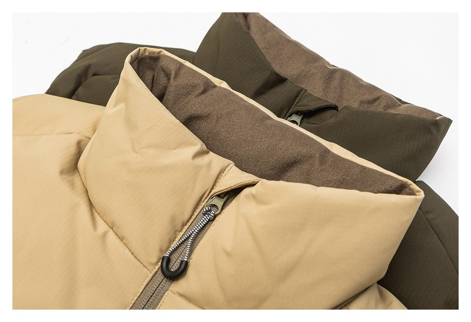 Close-up of tan and olive padded vests showing raised collars, brown lining and front zippers.