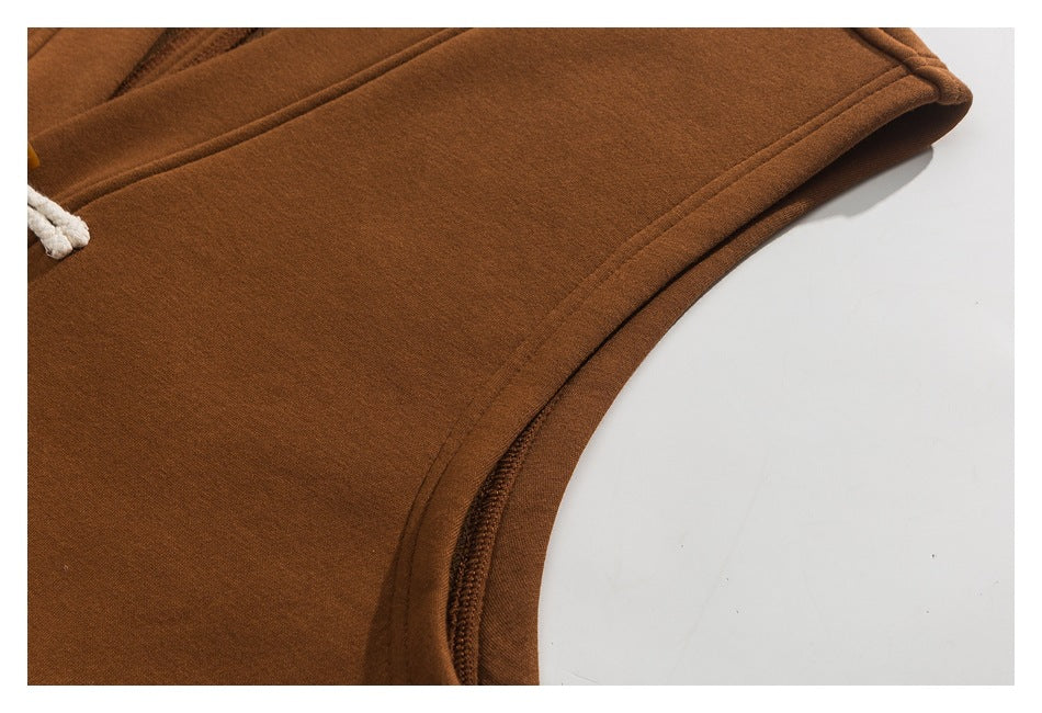 Close-up of the rust-brown coat's curved side seam and finished edge.