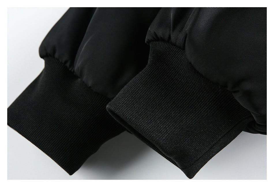 Close-up of the black jacket's gathered sleeve and wide ribbed cuff.