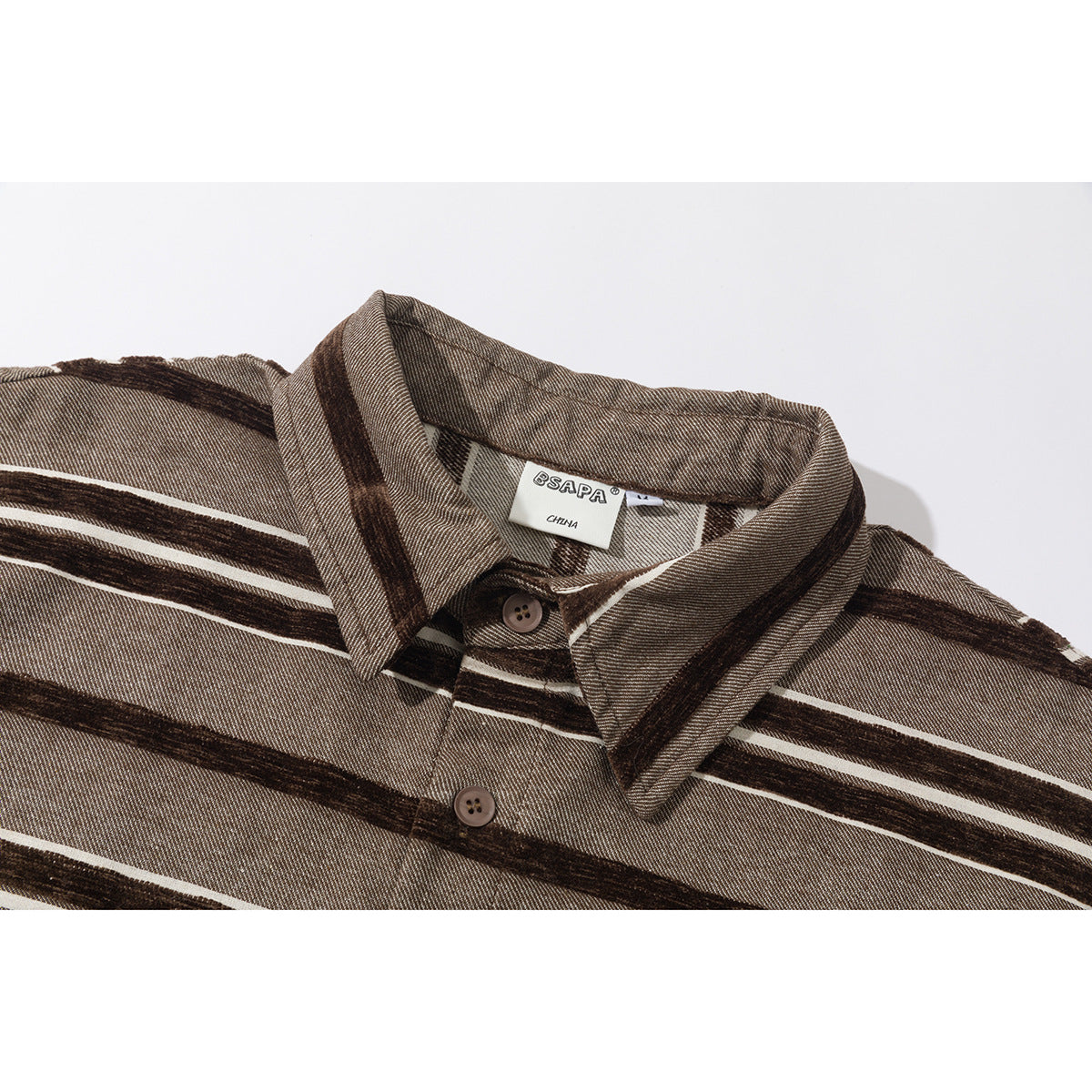 Close-up of a brown striped shirt collar, buttons, and sewn neck label.