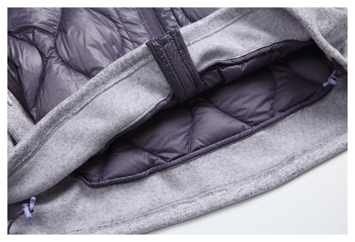 Open jacket close-up showing dark quilted lining, gray heather trim, and a stitched fabric tab.