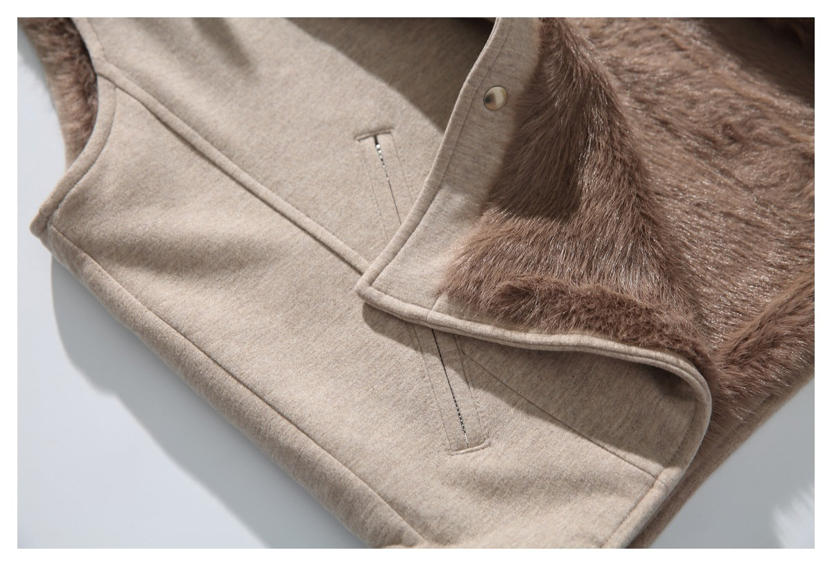 Close-up of an angled pocket and seam on the taupe vest beside its plush brown lining.
