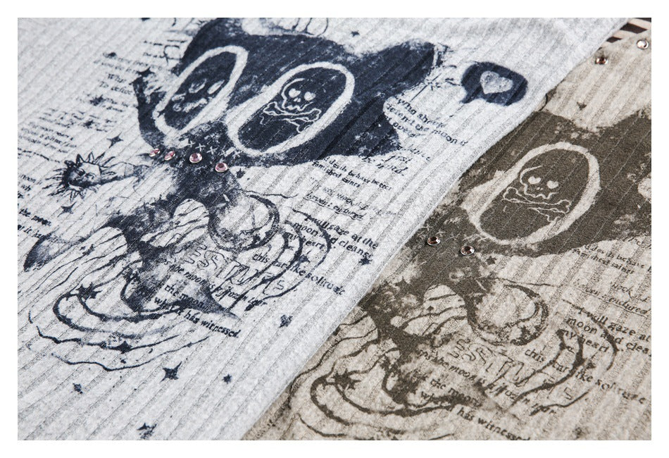 Close-up of gray and taupe striped tops with distressed skull-and-newspaper prints and metal studs.