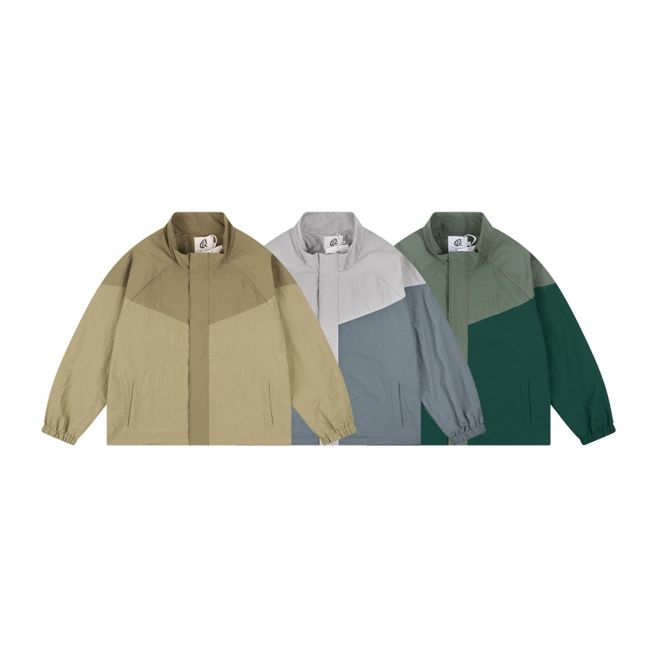 Three front views of color-block zip jackets in tan, light gray and slate blue, and green.