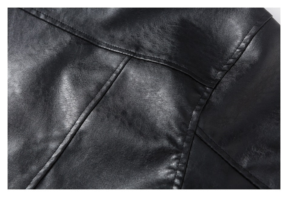 Close-up of a black jacket's back panel, showing curved and angled seams.