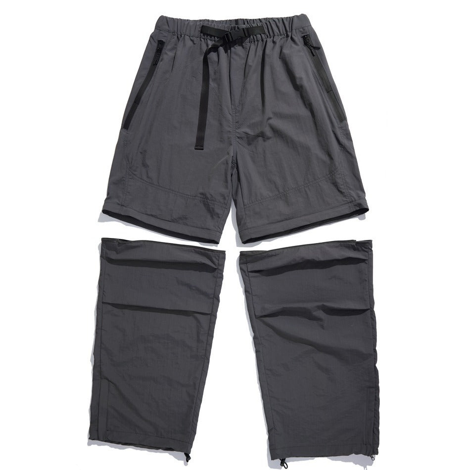 Flat lay of slate-gray convertible pants: zip-pocket shorts above two detachable lower-leg sections.