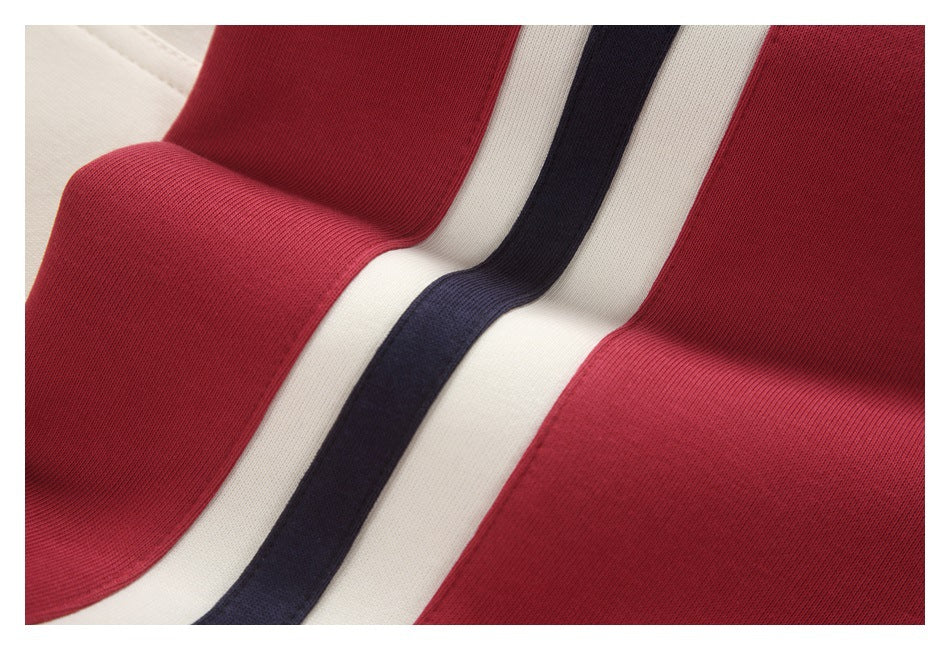 Close-up of a red garment with cream and navy stripes running between the panels.