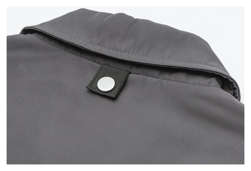 Close-up of a gray garment collar with a round snap fastener.
