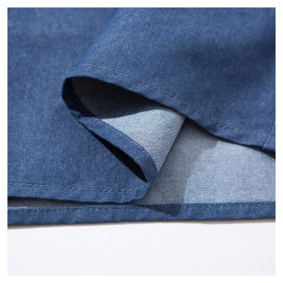 Close-up of the blue shirt hem showing the folded edge and contrasting inner face.