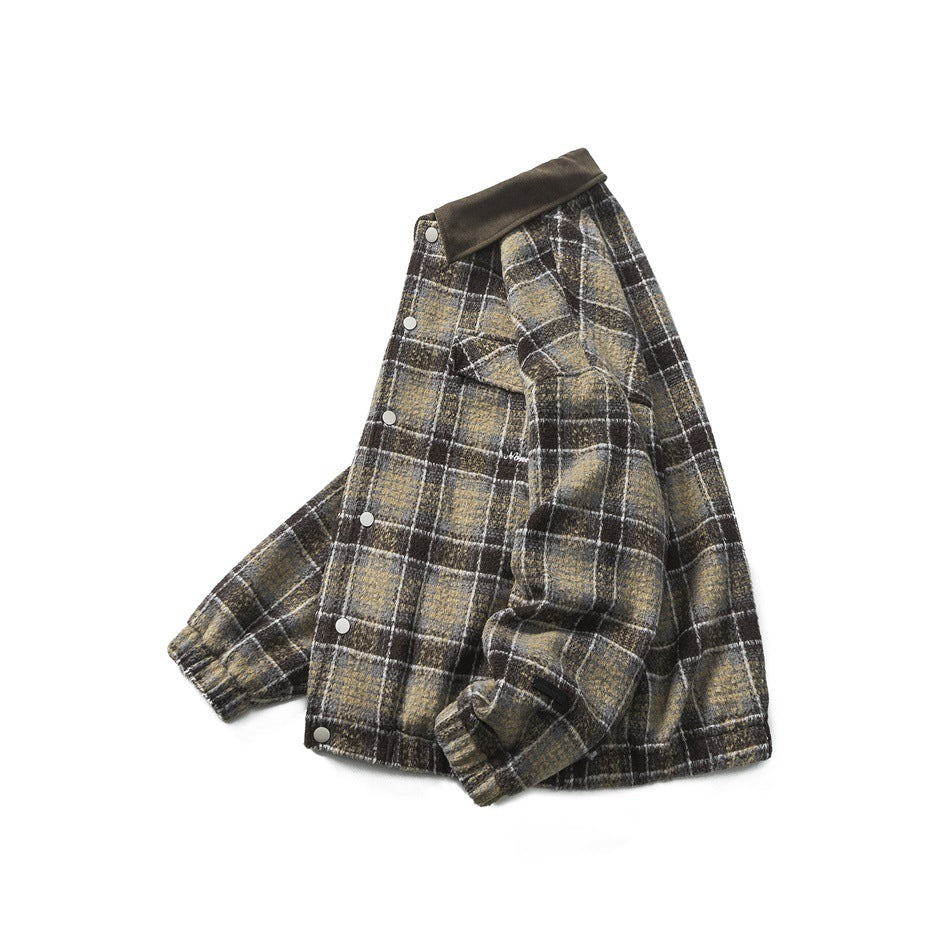 Plaid jacket displayed folded, with dark brown collar, silver snap buttons, and ribbed cuffs.