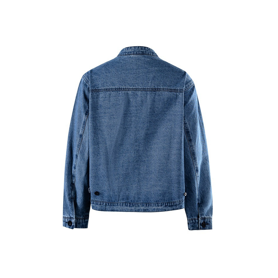 Back view of blue washed denim jacket with yoke seam, banded hem and button cuffs