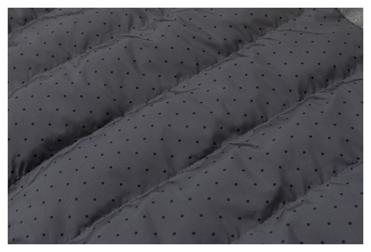 Close-up of dark gray dotted quilted lining with diagonal stitched channels.
