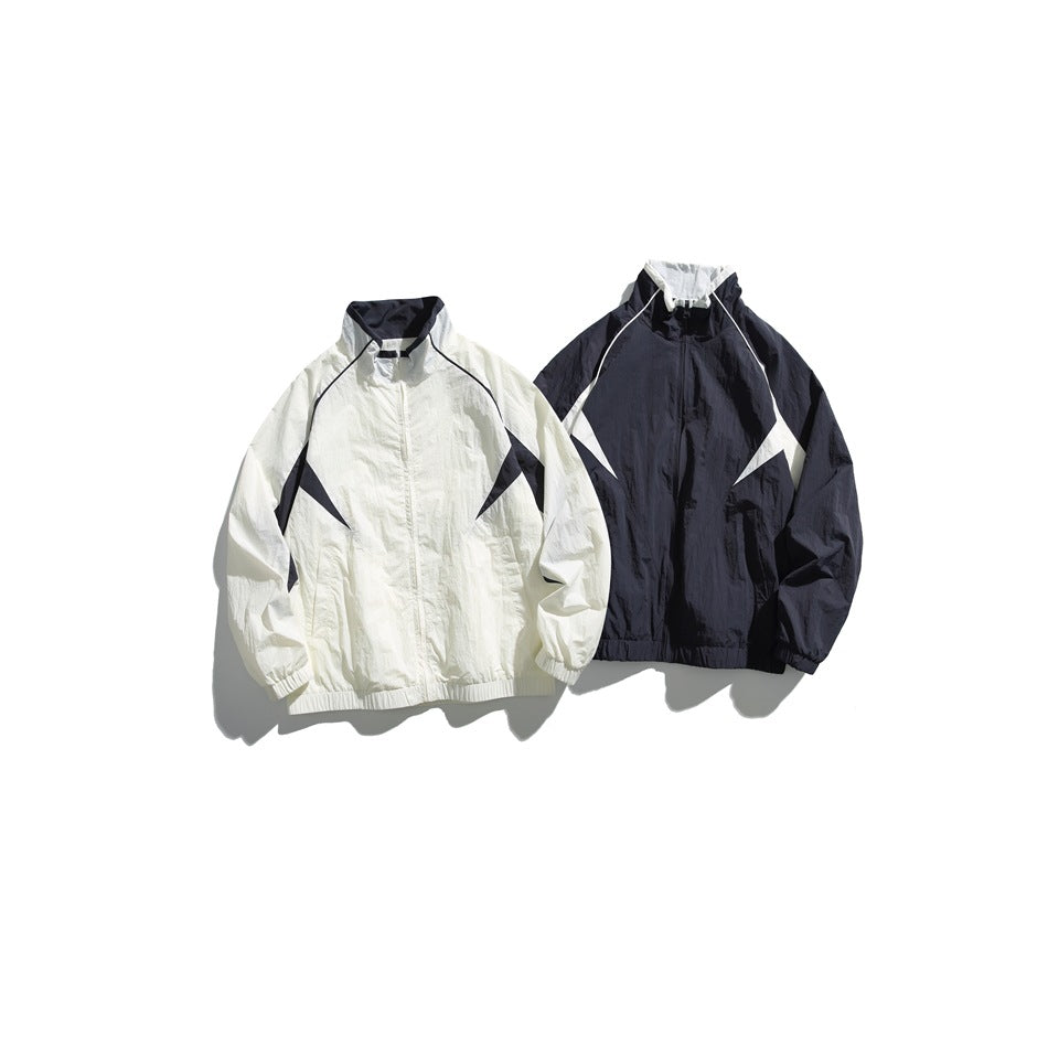 Two zip jackets displayed side by side: one white with dark panels and one dark with white panels.