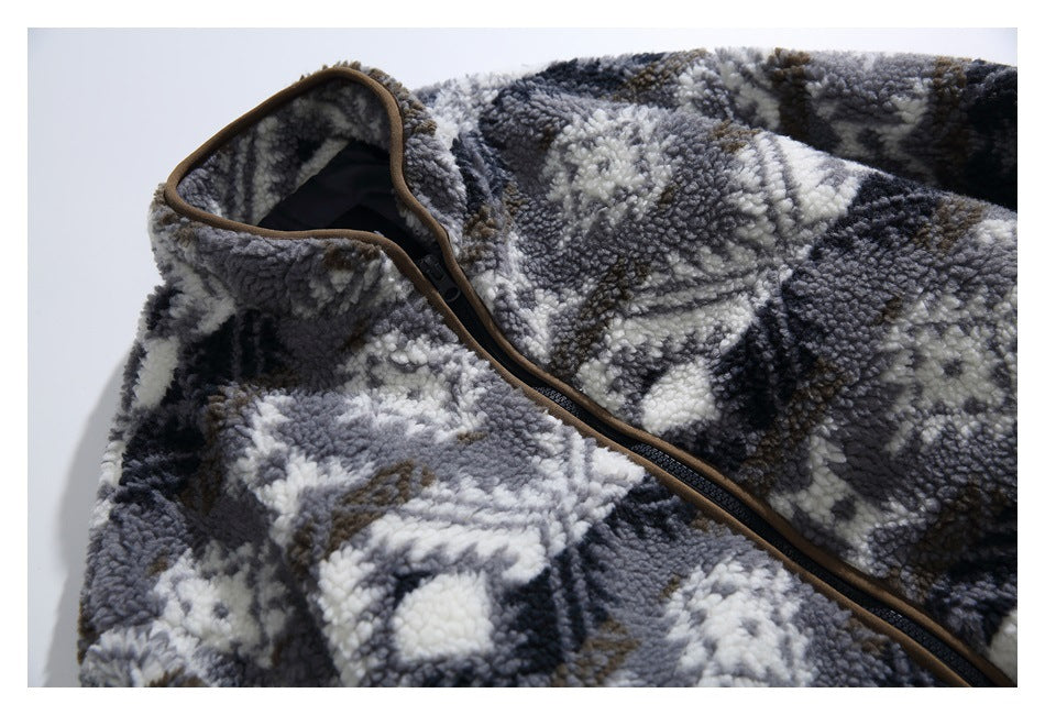 Close-up of a gray, black, and cream patterned fleece jacket with brown-trimmed collar and black zipper.