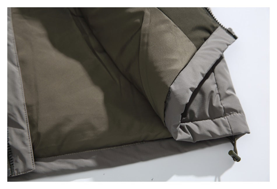Close-up of the jacket's gray-trimmed sleeve cuff and adjustable drawcord at the hem.