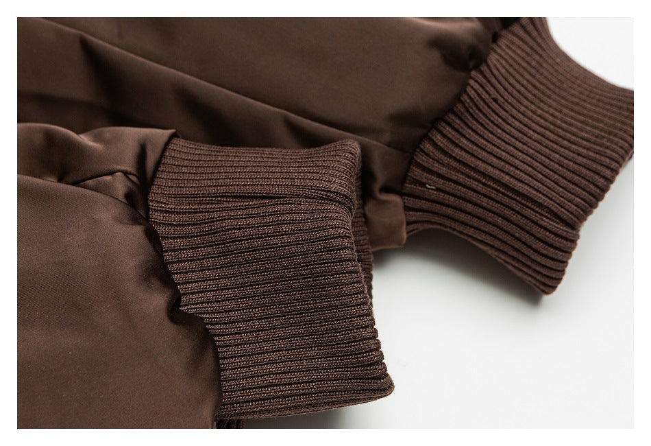 Close-up of dark brown ribbed cuffs on a jacket sleeve.