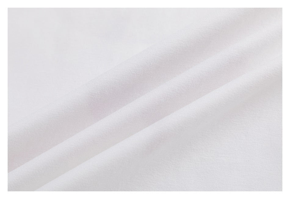 Close-up showing the fine texture of white shirt fabric and soft folds.