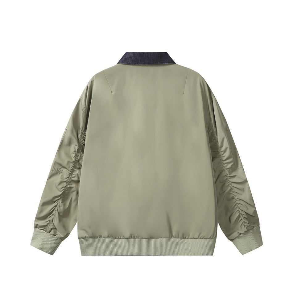 Back view of an olive jacket with a dark denim collar, gathered sleeves and ribbed cuffs and hem.