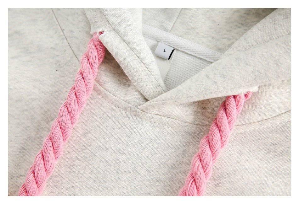 Close-up of a light gray heather hood with thick braided pink drawstrings and an L size tag.