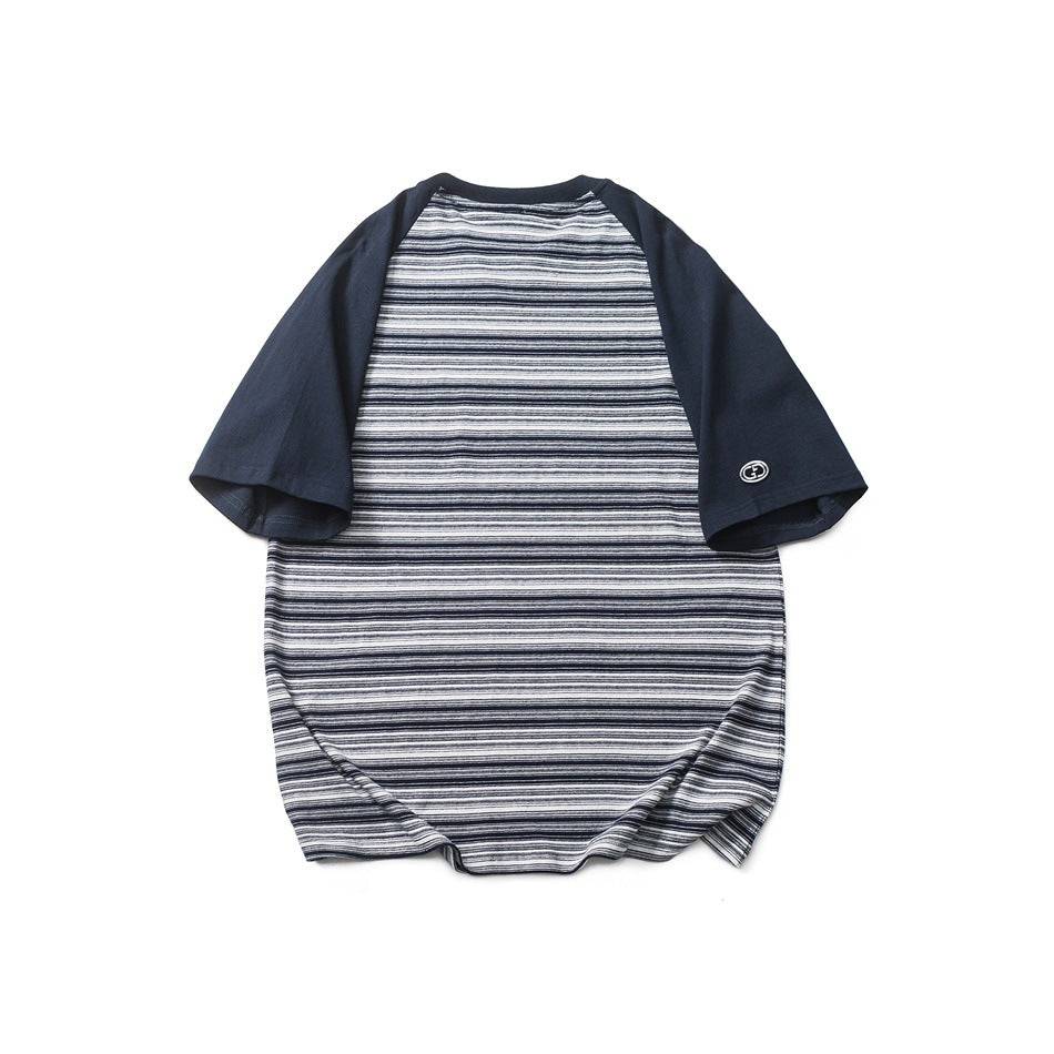 Back view of navy raglan-sleeve T-shirt with fine horizontal navy, white and gray stripes and a sleeve patch