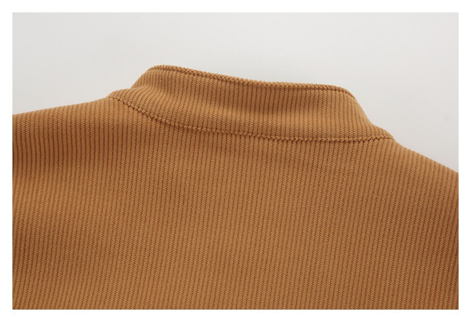 Close-up of the collar and upper back of a caramel-brown ribbed garment.